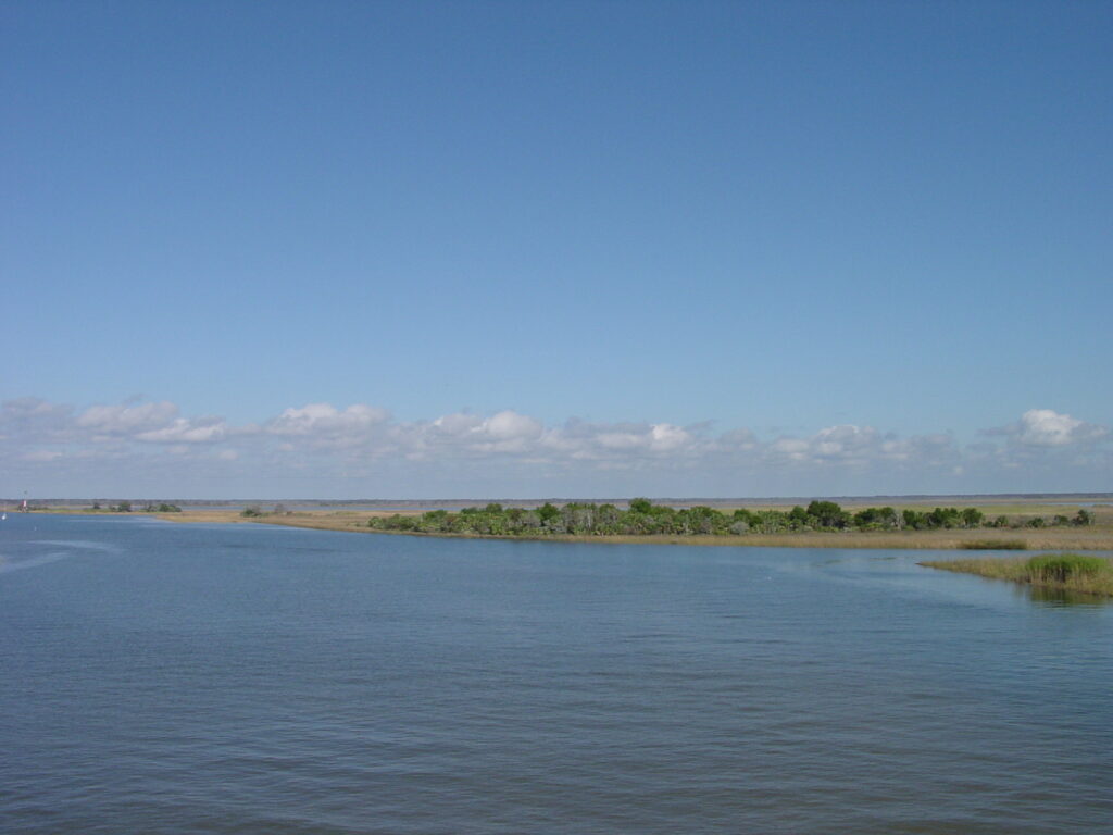 The still waters of Apalachicola Bay, filled with hardwood hammocks and marsh grass